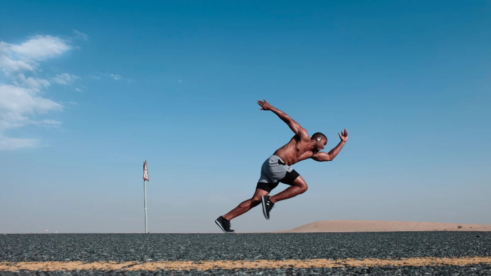 A runner sprinting on the beach